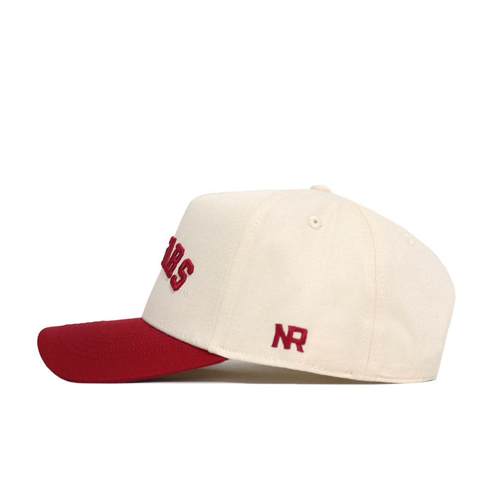 The Right Side Up Cougars Hat by No Rivals is a cream snapback with a red brim, red “NR” embroidery on the side, and red front text—shown in profile on a white background. Perfect for your gameday look!.