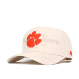 The Clemson Stacked Hat by No Rivals is a beige, officially licensed cap with an orange tiger paw print and "Tigers" embroidered on the front, plus a small orange logo on the left side of the brim. Structured fit.