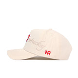 The Western Kentucky Stacked Hat by No Rivals is a beige cotton snapback with a structured fit, slightly curved brim, vent holes, "Kentucky" embroidered in cursive on the side, and red NR initials near the back.