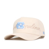 The No Rivals North Carolina Stacked Hat is a beige cotton cap with a light blue NC logo and "Carolina" in cursive. It features a structured fit, curved brim, adjustable snapback, and is officially licensed.