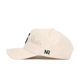 The No Rivals Michigan State Stacked Hat is a beige snapback made from high-quality cotton, featuring "State" embroidered in cursive on the side, "NR" stitched near the brim, a structured crown, and a curved visor.