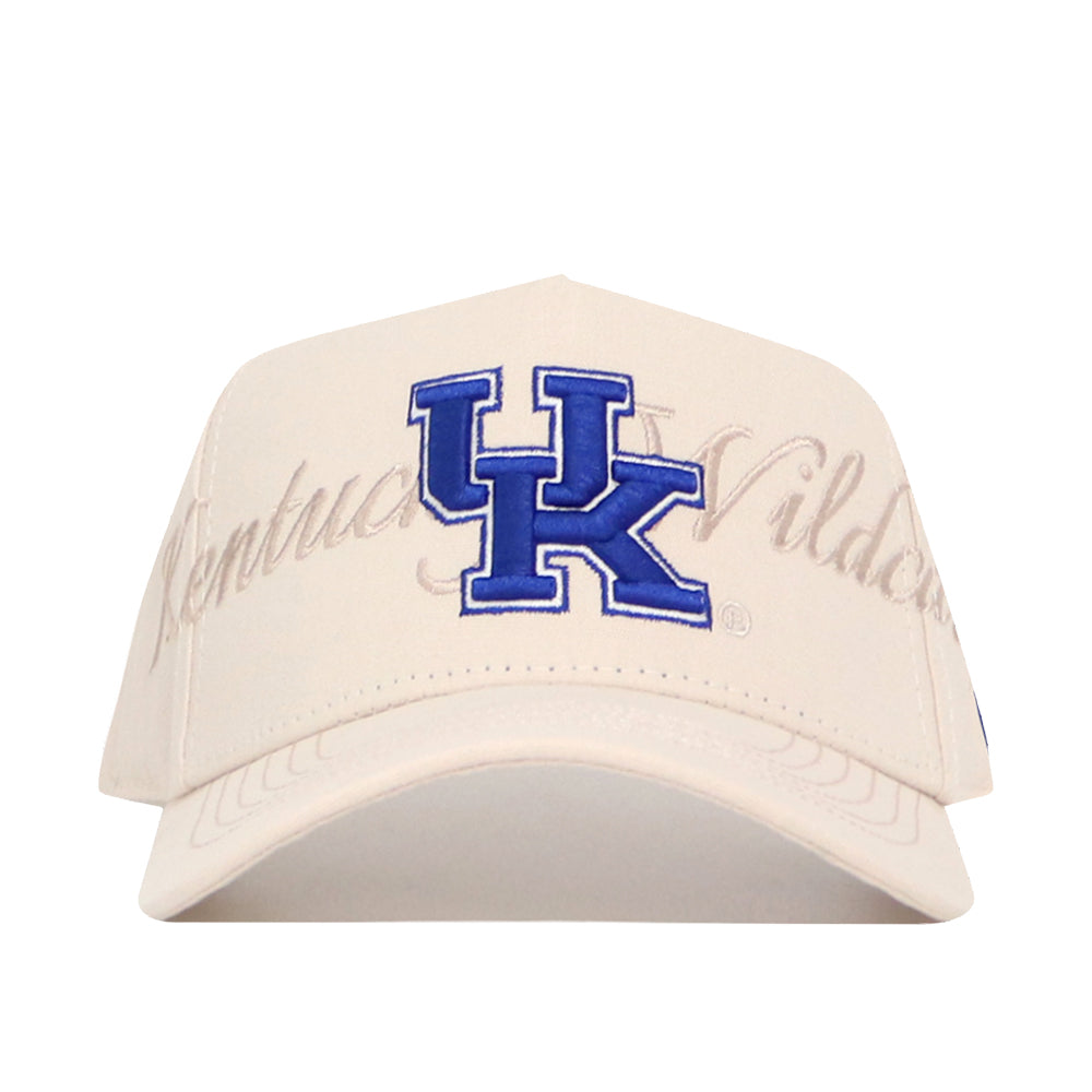 The No Rivals Kentucky Stacked Hat is a beige snapback made from high-quality cotton, with a large blue UK logo and "Kentucky Wildcats" script on the front; officially licensed for fans.