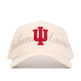 The Indiana Stacked Hat by No Rivals is an officially licensed cream snapback featuring a red IU logo and "Indiana Hoosiers" embroidered in light beige script on a high-quality cotton front panel.