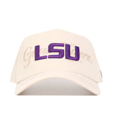 The No Rivals LSU Stacked Hat is a cream snapback with a structured fit, bold purple LSU embroidery on the front, and faint Geaux Tigers text in the background.