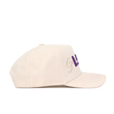 The No Rivals LSU Stacked Hat is a beige snapback, shown from the side, with tan and purple embroidered letters on the front. Made of high quality cotton, it features stitched eyelets, a structured fit, and a curved brim.