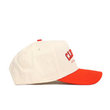 A cream-colored snapback hat from No Rivals, the Clemson Hometown Hat features a bright red brim, red top button, and side embroidery reading “CAL” with smaller text below. Shown in profile against a white background.