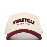 The Starkville Hometown Hat by No Rivals is a beige cotton cap with a maroon bill, "STARKVILLE" embroidered in large maroon letters and "MISSISSIPPI" below, featuring a comfortable structured fit.