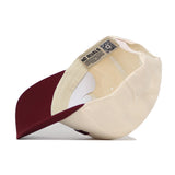 The Starkville Hometown Hat by No Rivals is a beige and maroon snapback, shown from underneath to reveal an inner label reading NO RIVALS and a QR code on the band. Made from high-quality cotton, it offers a comfortable, structured fit.