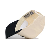 The Boone Hometown Hat by No Rivals is shown upside down, revealing its beige and black structured fit, inner lining, seams, snapback adjustment, inner tag, and a QR code label.