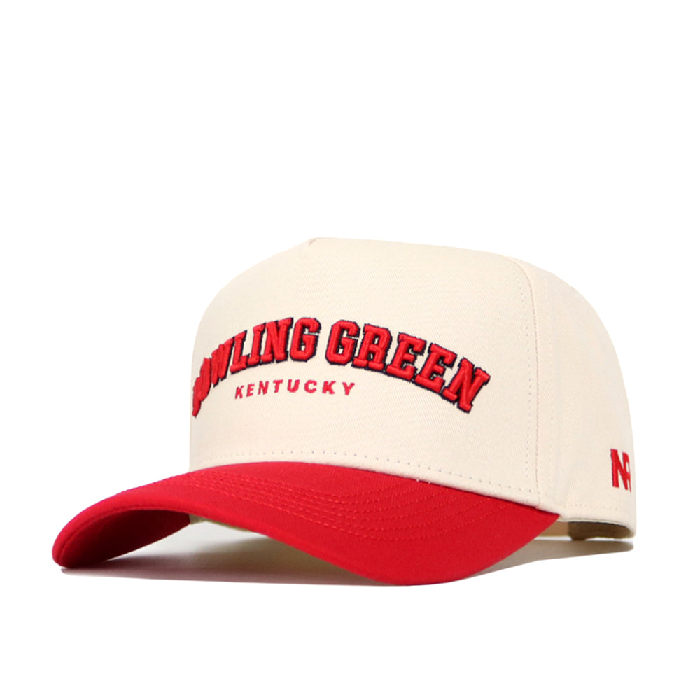 The Bowling Green Hometown Hat by No Rivals is a beige structured fit cap with "Bowling Green Kentucky" in red on the front, a red curved brim, side logo, and adjustable snap back. Crafted from high quality cotton for comfort and style.