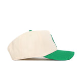 The North Texas Logo Patch Hat by No Rivals is a beige snapback with a green brim and top button, made from high-quality cotton. Shown in a side view against a white background.