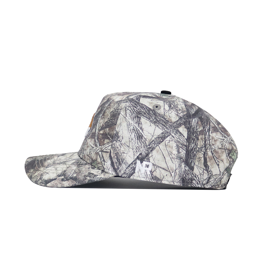 A side view of the No Rivals Montana State Outland Hat, a camouflage-patterned snapback in green, brown, and gray cotton with a flat brim and no visible logos or designs on this side.