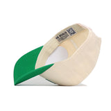 The North Texas Logo Patch Hat by No Rivals is shown upside down, revealing inside details like a NO RIVALS fabric label and a QR code on the inner band. Made from high-quality cotton for comfort and durability.