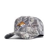 The No Rivals Montana State Outland Hat is a camouflage cotton cap with a gold and white wildcat logo on the front, shown at an angle on a white background. This adjustable hat combines comfort and style for any occasion.