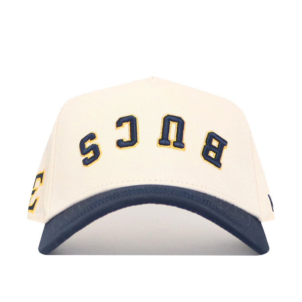 The No Rivals Upside Down BUCS Hat - ETSU - Classic Colors is a structured white snapback with a dark blue brim, made from high-quality cotton. "BUCS" is embroidered upside down in bold blue and yellow on the front.