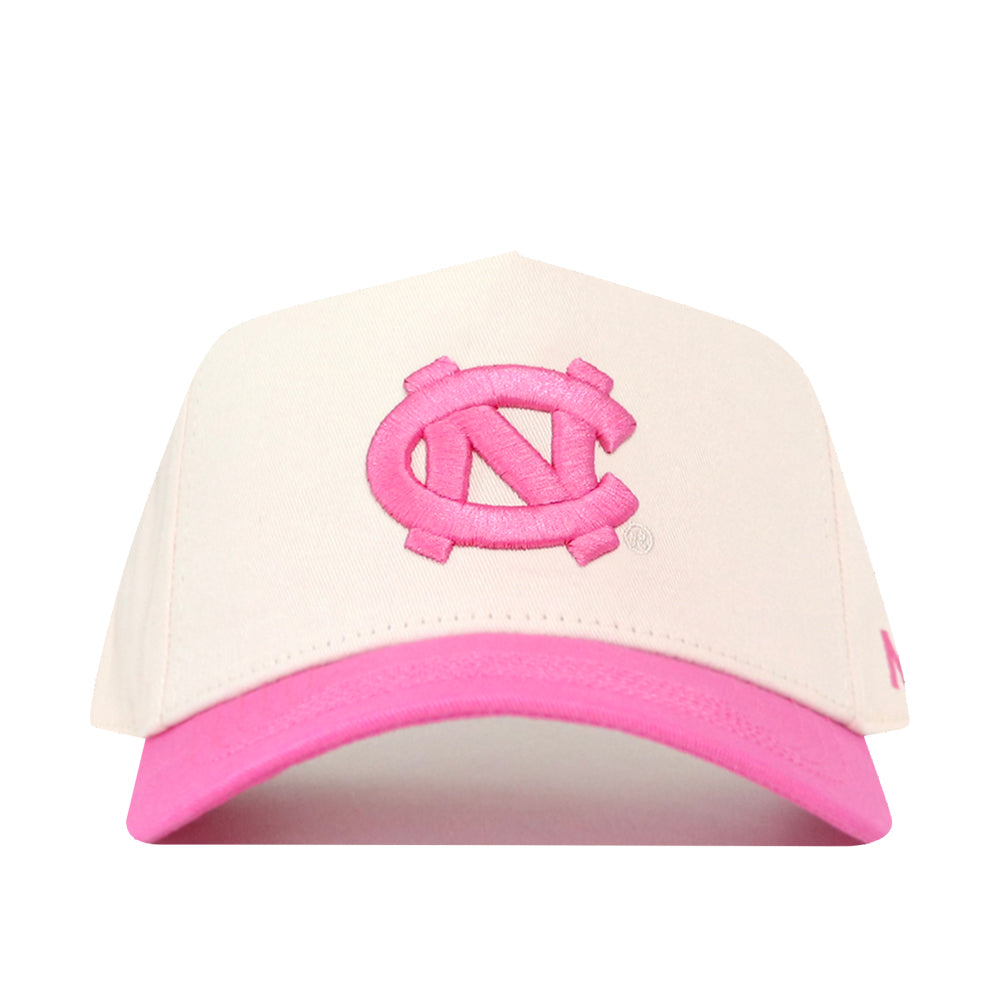 The No Rivals North Carolina Pink Out Hat is a white baseball cap with a pink brim, featuring a large pink interlocking NC logo embroidered on the front. This officially licensed snapback combines comfort and style while supporting an important cause.
