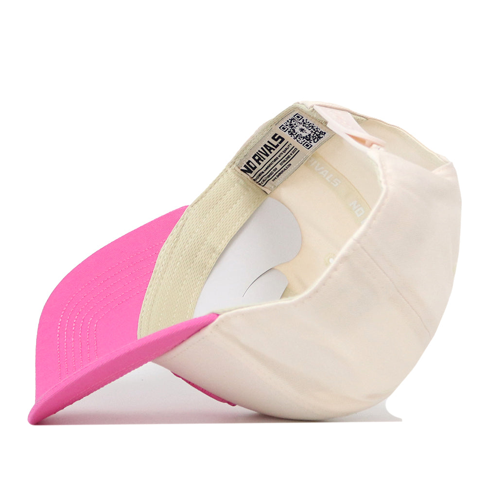 The North Carolina Pink Out Hat by No Rivals is displayed upside down, revealing its light pink and white inner lining, detailed stitching, and a visible label featuring both text and a QR code. This officially licensed snapback combines meaningful style with quality craftsmanship.