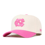 The No Rivals North Carolina Pink Out Hat is a cream baseball cap with a pink bill and a pink embroidered NC logo on the front. This officially licensed snapback also features additional pink lettering on the side.