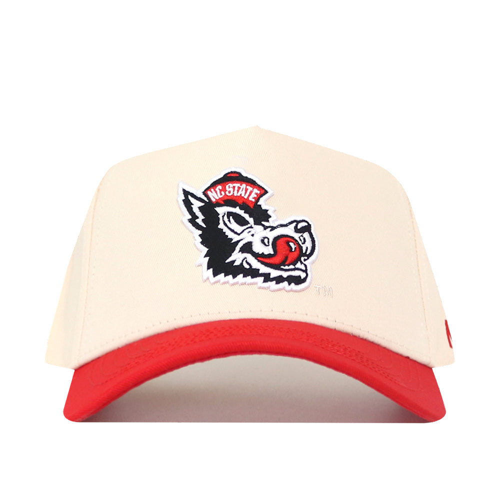 No Rivals NC State Slobbering Wolf Hat featuring an off-white snapback with a red brim and an embroidered patch of a wolf wearing a red hat with NC STATE text.