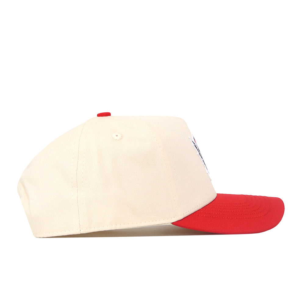 Cream-colored No Rivals NC State Slobbering Wolf Hat snapback with a red brim and red top button, featuring embroidered wolf mascot graphics on the side.