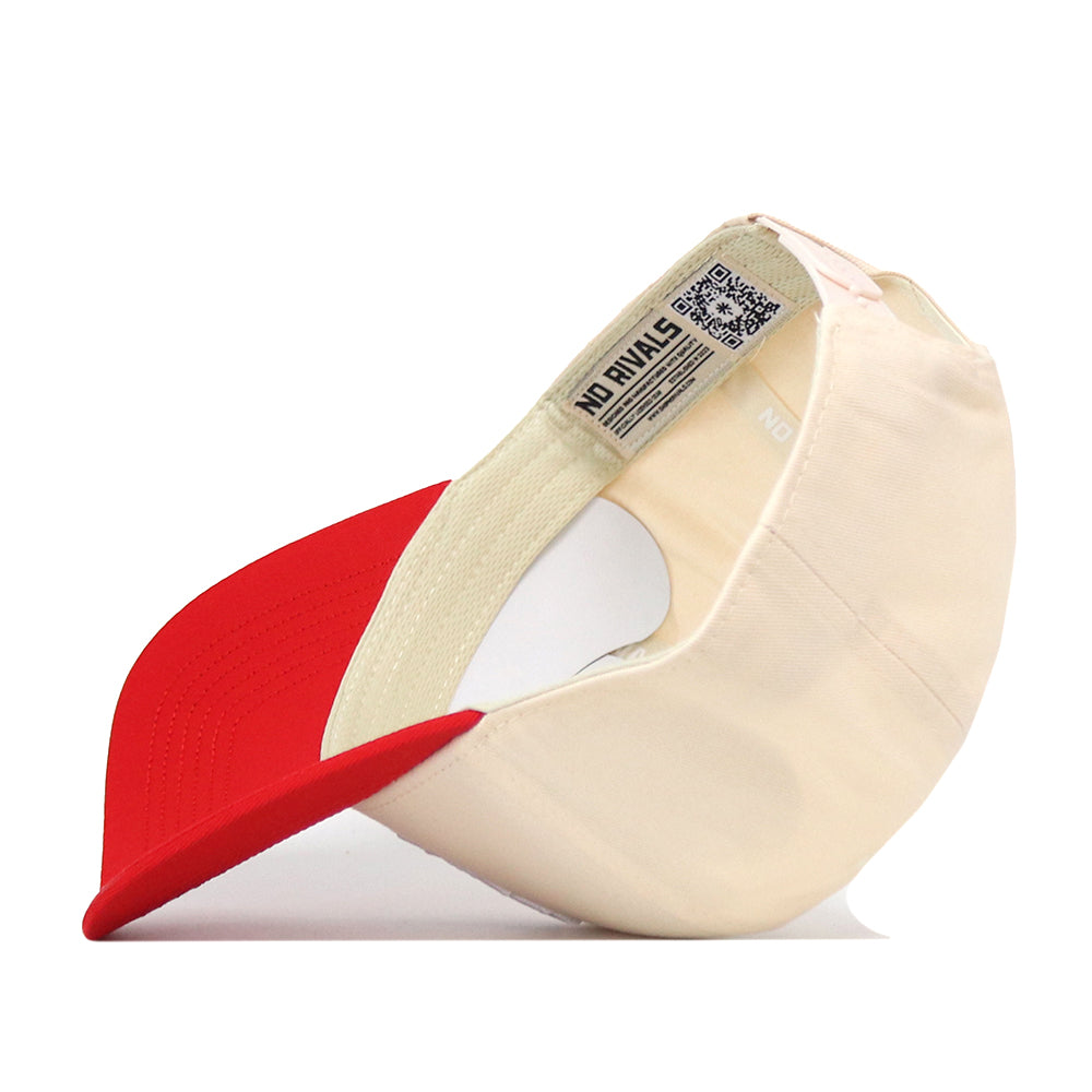 Side view of a cream-colored 5-panel NC State Slobbering Wolf Hat with a red brim, showing the interior label.