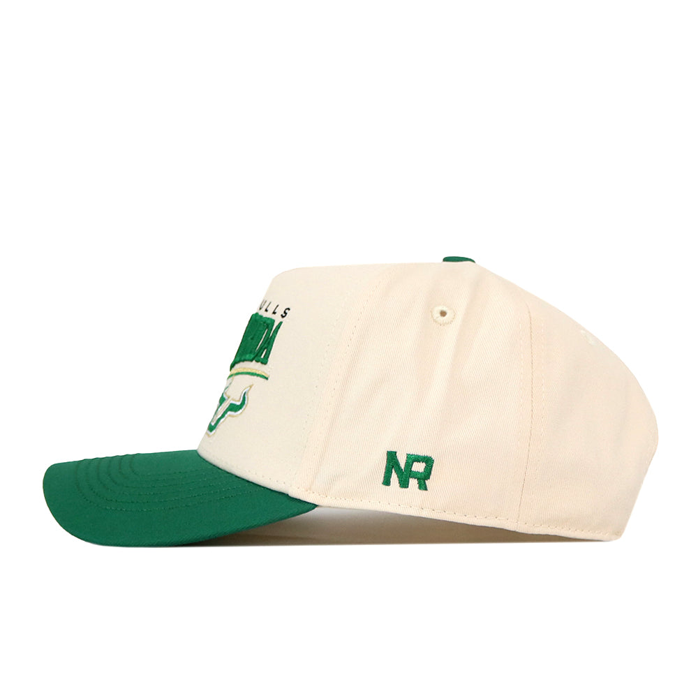 Cream-colored No Rivals USF Stride Hat featuring a green brim and green embroidered logos on the front and side.