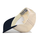 An upside-down Akron Zips Vintage Hat showing the interior labels and a QR code on the sweatband.