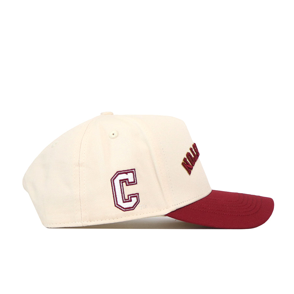 Side view of the No Rivals College of Charleston | Upside Down Charleston Hat - Classic baseball cap in cream, featuring a red brim. The letter “C” is stitched in maroon on the side, with part of a maroon and gold word displayed on the front. This officially licensed snapback combines classic style and premium craftsmanship.