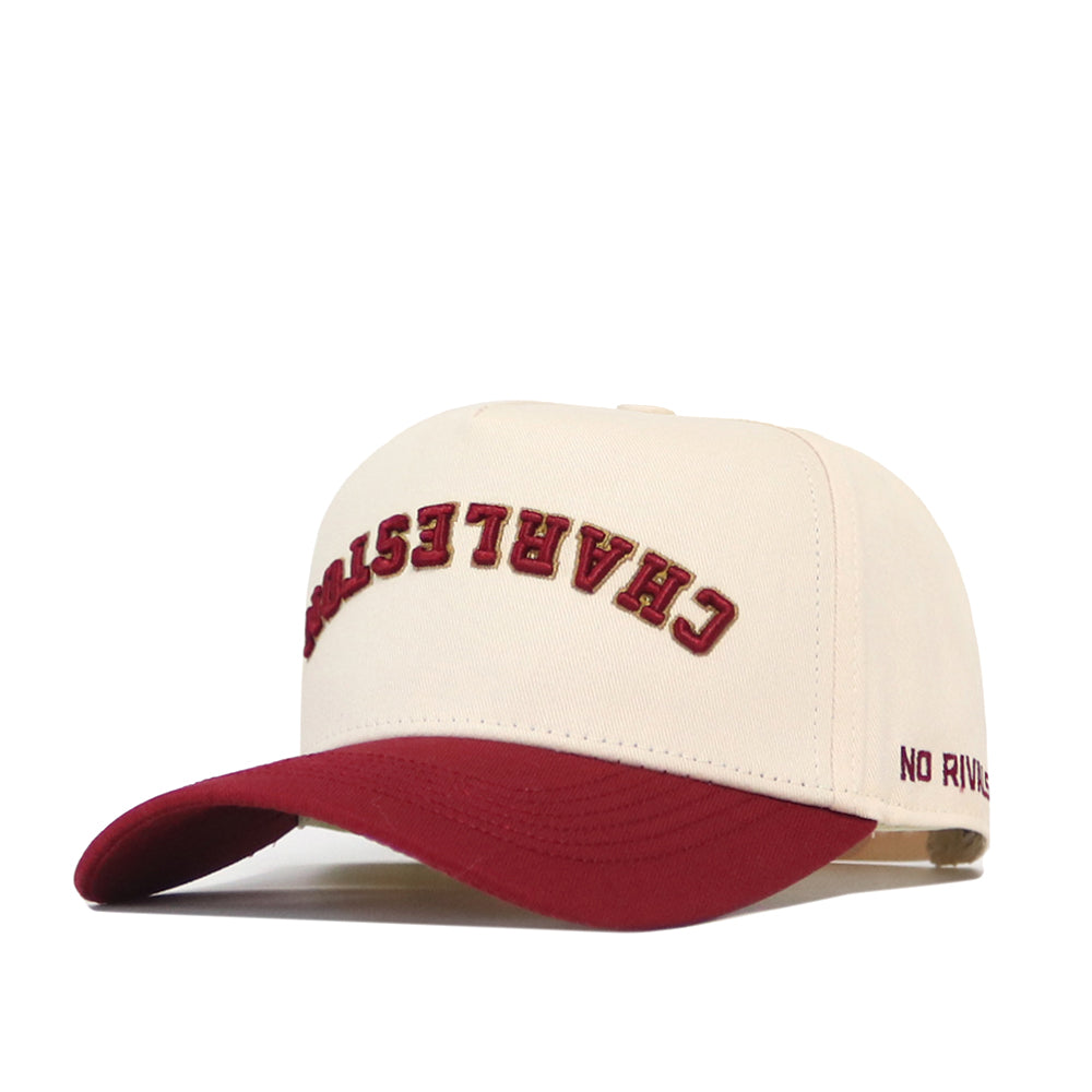 Show your Cougar pride with the College of Charleston | Upside Down Charleston Hat - Classic by No Rivals. This cream and red, officially licensed snapback features “CHARLESTON” curved on the front and “NO RIVALS” stitched on the side of the bill, delivering standout style and team spirit.