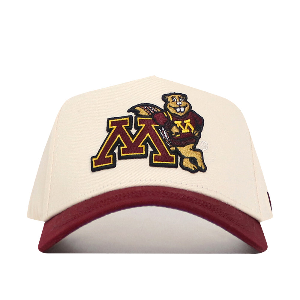 The No Rivals Minnesota Gophers Patch Hat is a cream-colored snapback with a maroon brim, featuring an oversized, officially licensed maroon and gold “M” alongside a cartoon gopher mascot embroidered on the front.