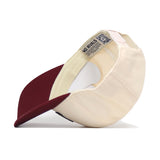 The Minnesota Gophers Patch Hat by No Rivals is displayed upside down, showcasing its inner labels, stitching details, and officially licensed embroidered logos. This cream and maroon snapback cap features a curved brim and includes a QR code on one of the inside tags.