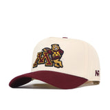 Introducing the Minnesota Gophers Patch Hat by No Rivals—a cream-colored snapback cap with a maroon brim. The front showcases embroidered logos of the University of Minnesota mascot and M logo, while “NR” is stitched on the side of the brim. This officially licensed hat is a must-have for any dedicated Minnesota fan.