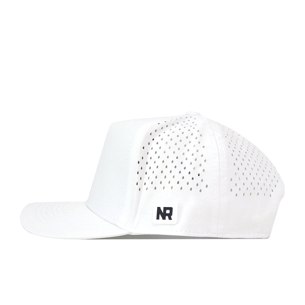 The Creighton Bluejays Baseball Hat in white by No Rivals features small perforated holes on the sides and a black embroidered NR logo patch on the lower left side. Made from performance fabric, this snap back cap is showcased in a side profile view against a white background.