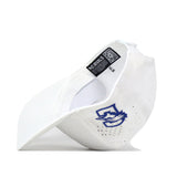 A white “Creighton Bluejays Volleyball Hat” by No Rivals is shown from the inside, revealing a blue embroidered stylized bird logo on the side and interior black tags with text and a QR code. The brim of the hat is positioned facing left.