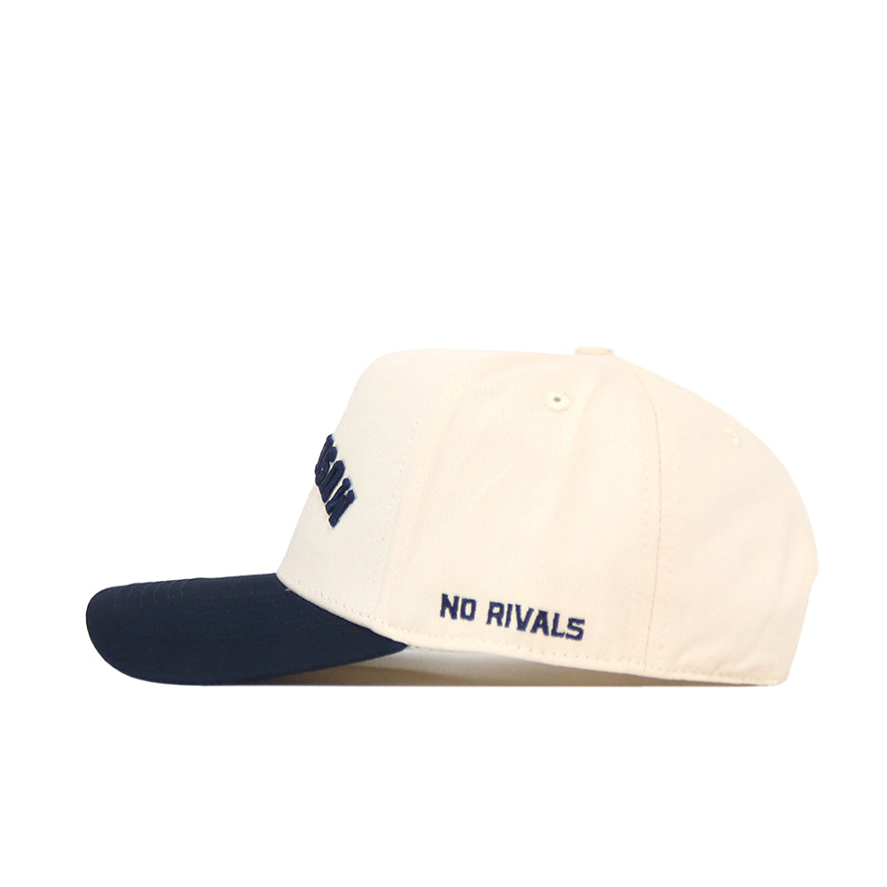 Show your school spirit with the Xavier Musketeers | Upside Down Musketeers Hat - Classic by No Rivals. This officially licensed snapback features a cream color, a navy blue brim, and “NO RIVALS” embroidered on the side in navy text—combining comfort and standout style for any fan.