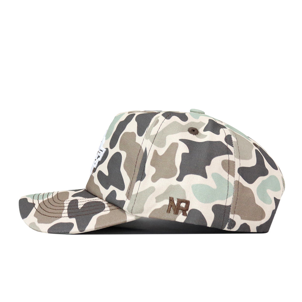 The UCF Knights Huntsman Hat by No Rivals is a camouflage-pattern baseball snapback featuring an embroidered white patch on the front and brown NR letters on the side. Shown in a side profile view against a white background, this adjustable cap delivers both style and comfortable fit.
