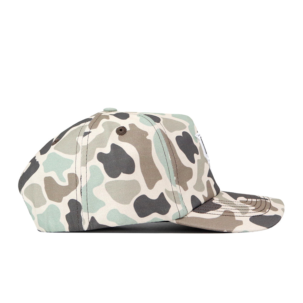 The UCF Knights Huntsman Hat by No Rivals is an adjustable cotton cap featuring a green, tan, and black camouflage pattern, displayed from the side against a white background.