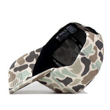 The Ole Miss Rebels Huntsman Hat by No Rivals, featuring a camouflage pattern and crafted from high quality cotton, is displayed on its side to reveal the inside label with “NO RIVALS” printed on it and a visible QR code under the brim.