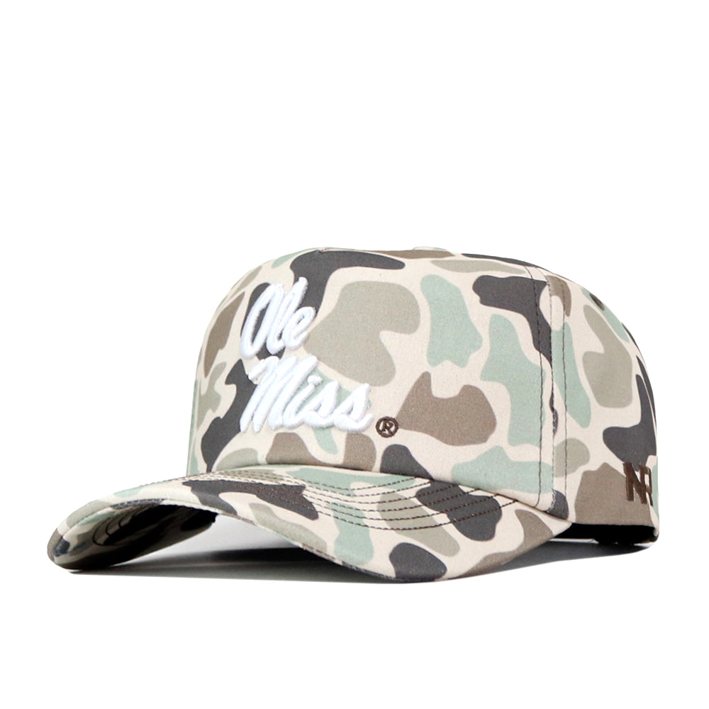 Introducing the Ole Miss Rebels Huntsman Hat by No Rivals: This officially licensed snapback features a camo design crafted from premium cotton, with “Ole Miss” embroidered in white across the front and “No Rivals” stitched on the side. The cap is displayed at an angle to highlight both its brim and detailed side accents.