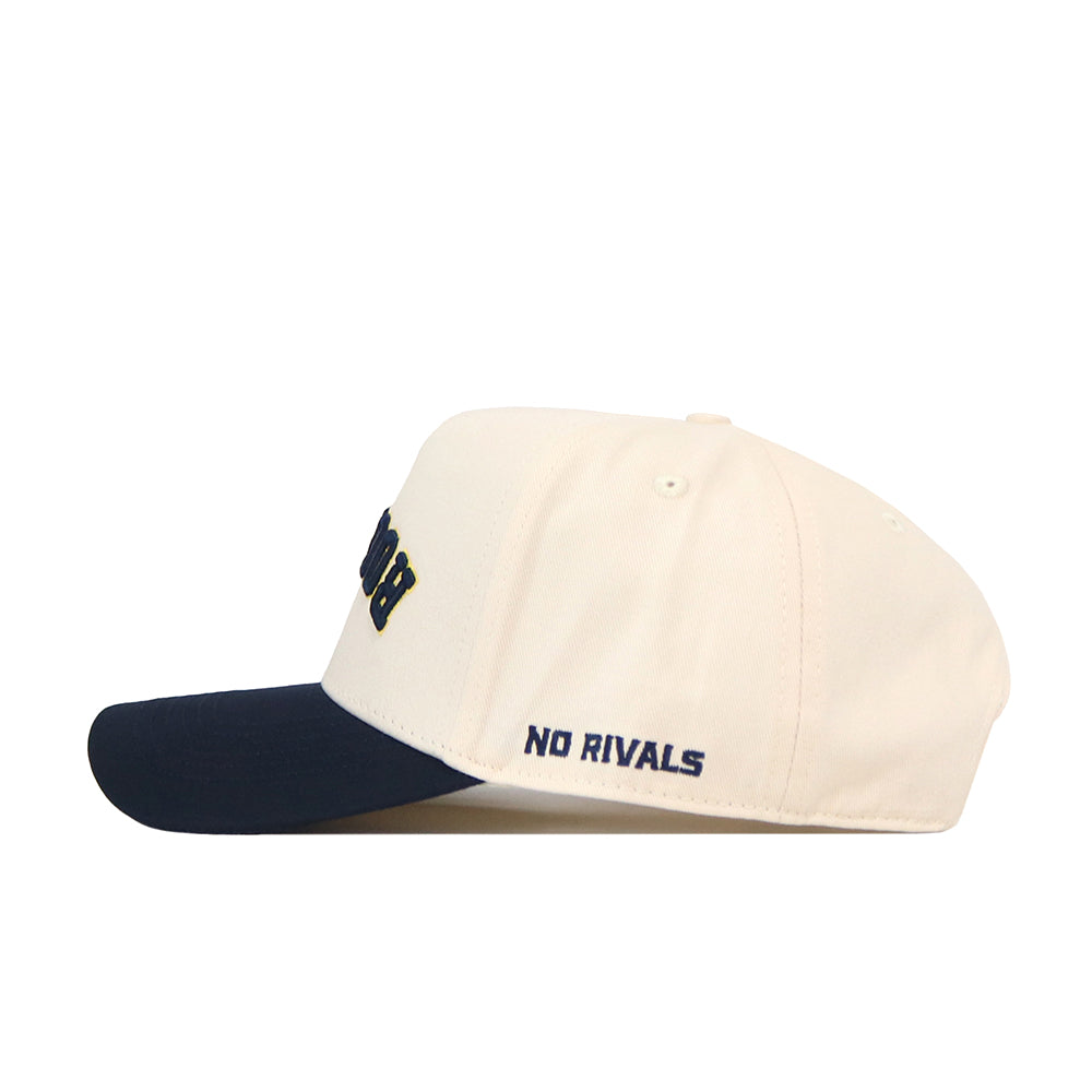 Introducing the Toledo Rockets | Upside Down Rockets Hat - Classic by No Rivals: This white snapback baseball cap features a navy blue brim and “NO RIVALS” embroidered in navy on the side. As an officially licensed accessory, it’s perfect for fans and makes a stylish addition to any Toledo Rockets hat collection.