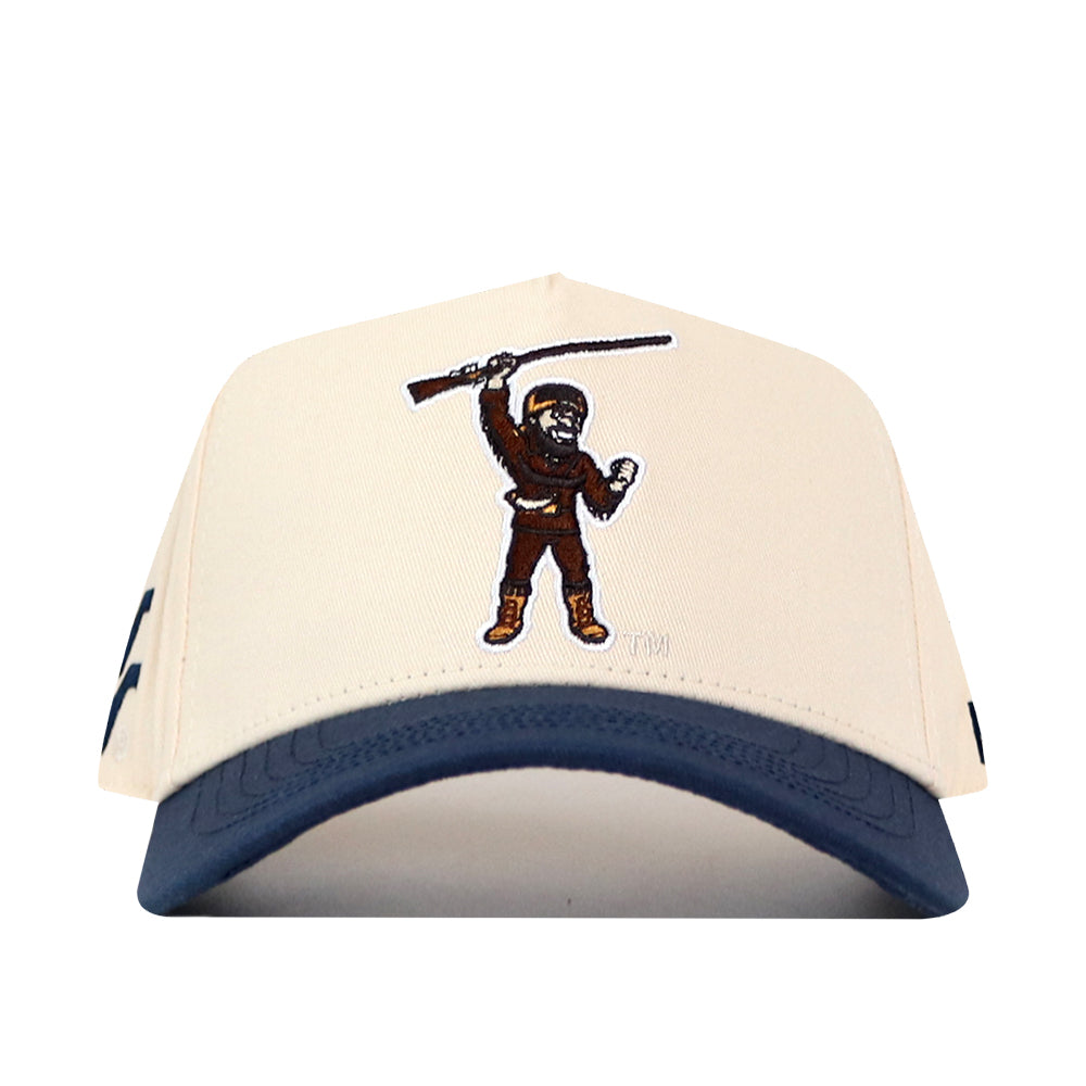 Introducing the No Rivals WVU Mountaineers Mascot Patch Hat—a beige and blue baseball cap crafted from performance fabric, featuring an embroidered patch of the Mountaineers mascot holding a rifle above their head. Designed for ultimate comfort, it includes a snap back closure for a perfect fit.