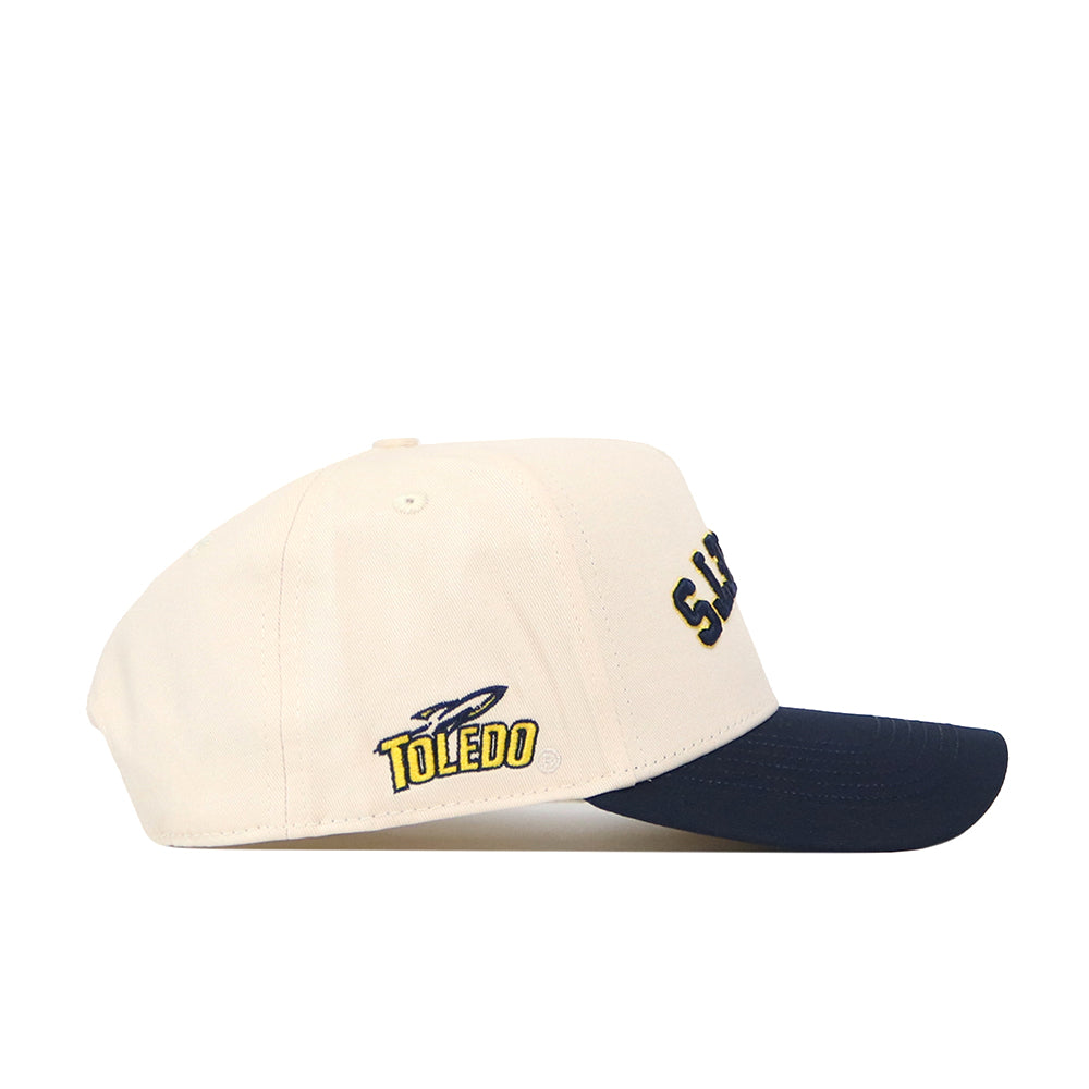 Show your team spirit in style with the officially licensed Toledo Rockets | Upside Down Rockets Hat - Classic by No Rivals. This cream-colored snapback baseball cap features a navy blue brim, the word “TOLEDO,” and an embroidered rocket logo on the side.