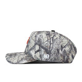 A side view of the No Rivals Bowling Green State Falcons Outland Hat showcases a white embroidered NR logo on the lower side and subtle red embroidery on the front. This camouflage baseball cap features a flat brim, classic woodland pattern, and an adjustable snapback—making it the perfect Gameday Fit.