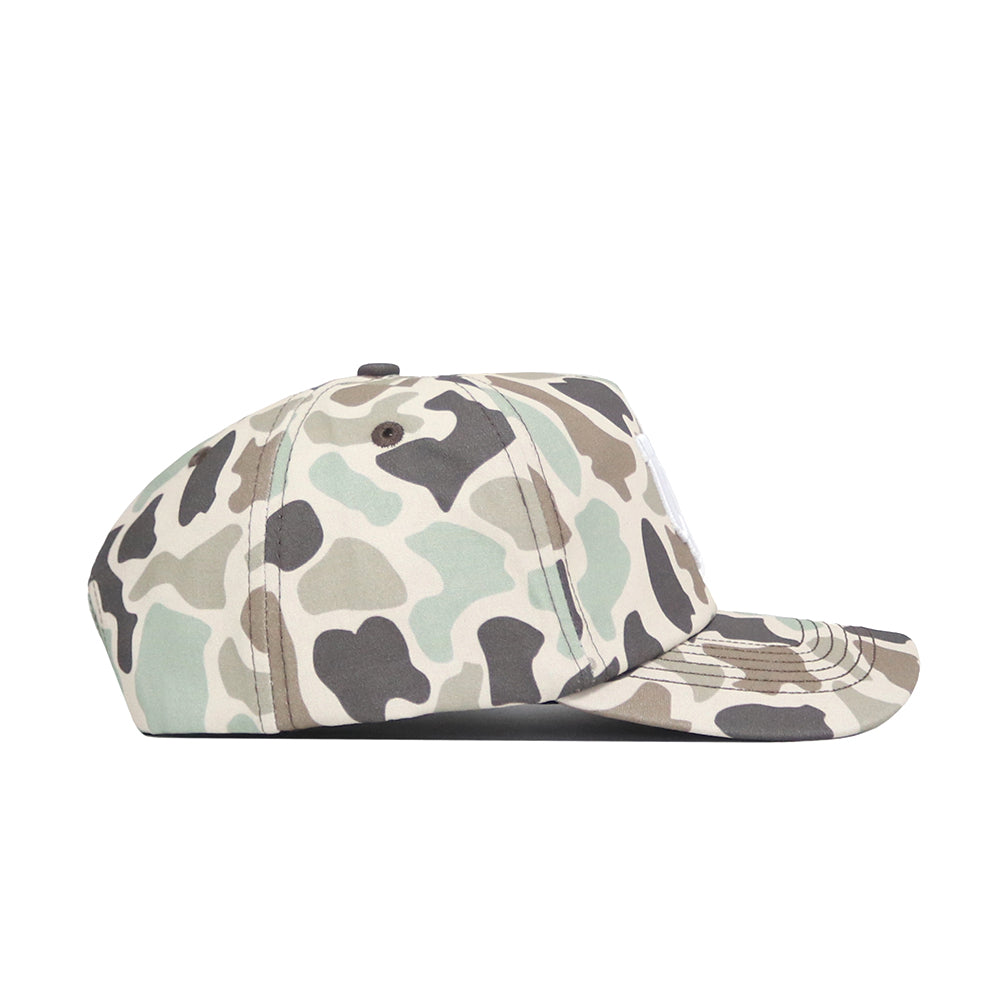 A side view of the No Rivals Utah Huntsman Hat, a 5-panel cap with a green, beige, and brown duck camo pattern, displayed on a plain white background.