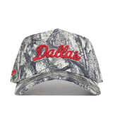 The SMU Outland Hat by No Rivals is a cotton camouflage snapback baseball cap with "Dallas" embroidered in red script on the front. This officially licensed hat offers standout style and a perfect fit.