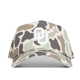 The Oklahoma Huntsman Hat by No Rivals is a duck camo 5-panel baseball cap with a white OU logo on the front, snap back closure, and is shown on a white background.
