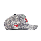 The No Rivals SMU Outland Hat is a camouflage snapback made of high-quality cotton with red embroidered details—a horse and a stylized D on the side—shown in left side profile against a white background.