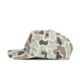 A side view of the No Rivals Oklahoma Huntsman Hat in duck camo with green, beige, and brown shades, featuring a 5-panel design and embroidered NR initials on the side.