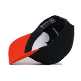 The Clemson Tailgate Hat by No Rivals is shown upside down, displaying its red brim, black cotton body, and structured fit. Inside, a tag reads NO RIVALS.