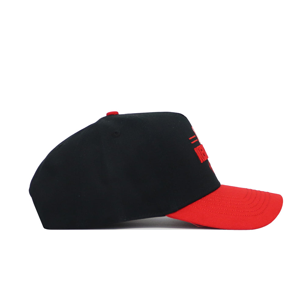 The No Rivals Nebraska Tailgate Hat is a black snapback with a bright red curved brim and red accents, crafted from high quality cotton with a structured fit. Shown from the side on a white background.